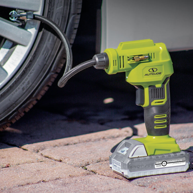 Sun Joe 24-Volt Cordless Portable Air Compressor Kit filling up a car tire.