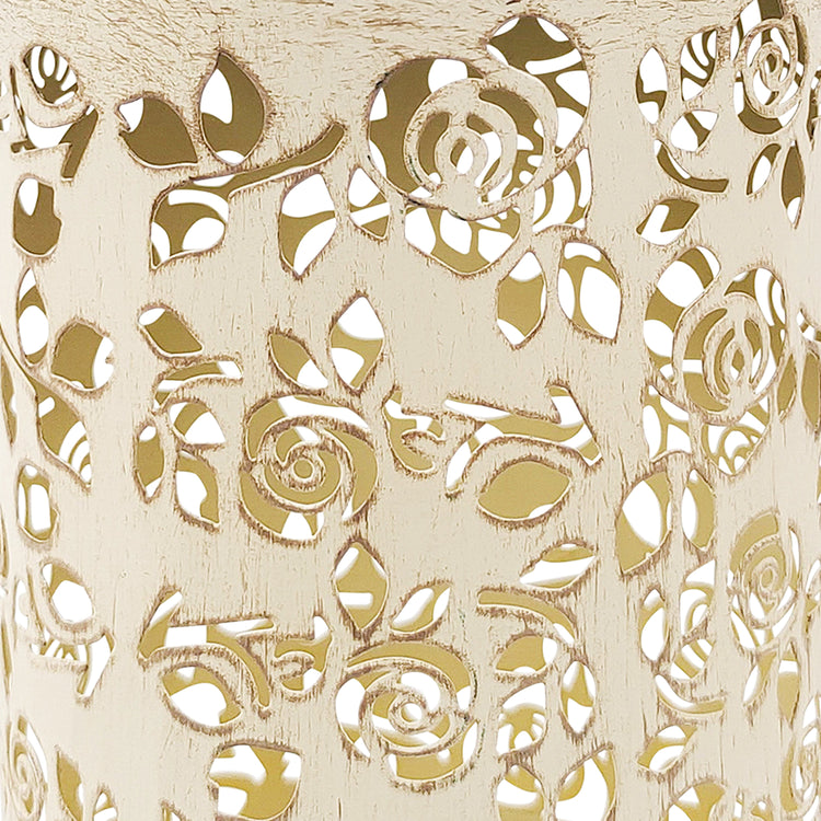 Close-up of the antique white hand-painted finish and rose pattern.