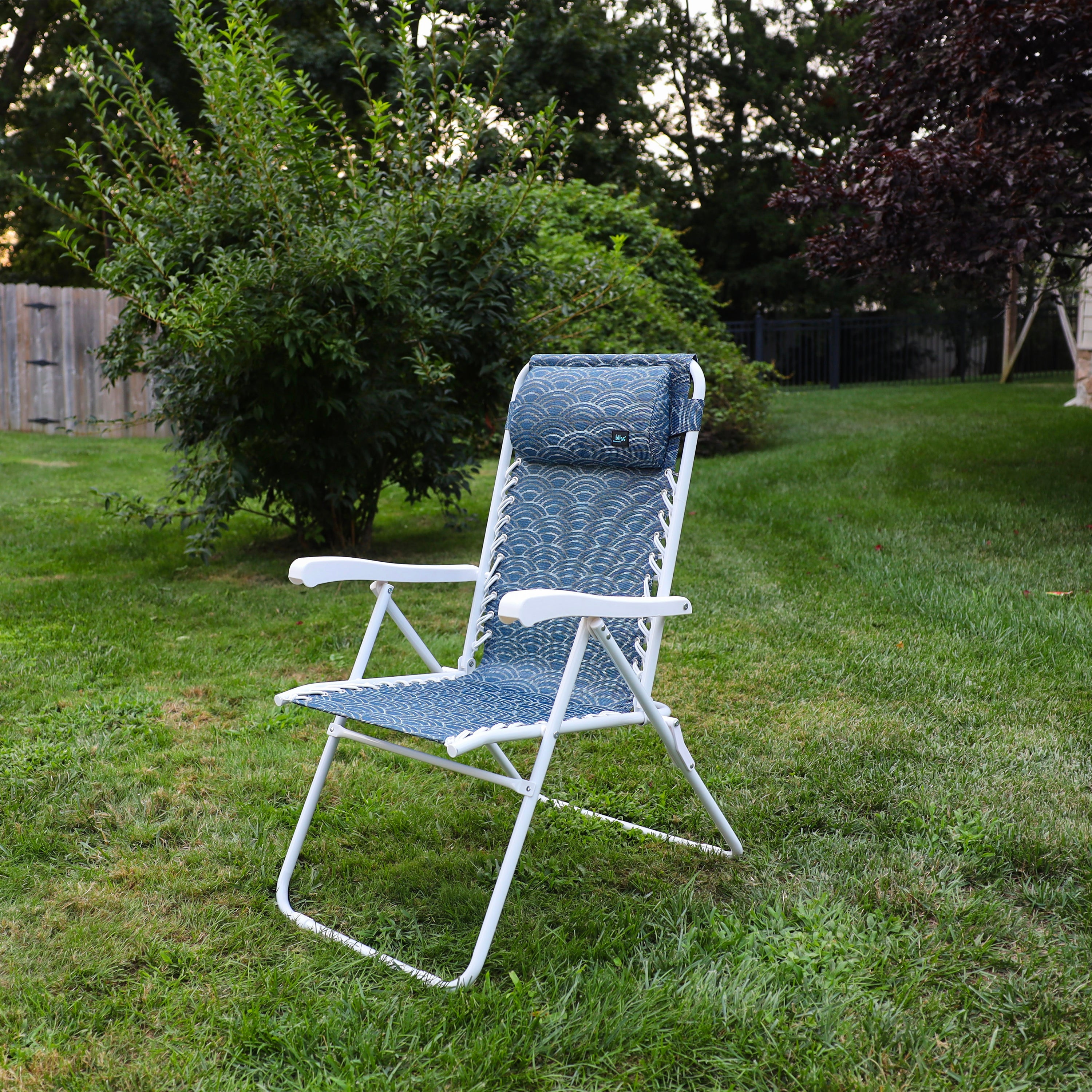 Angled view of the 26-inch Blue Scallop Reclining Sling Chair on a lawn.