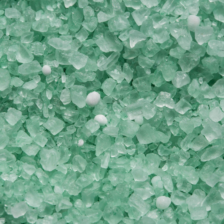 Close-up of the green Premium Enviro Blend Ice Melter.