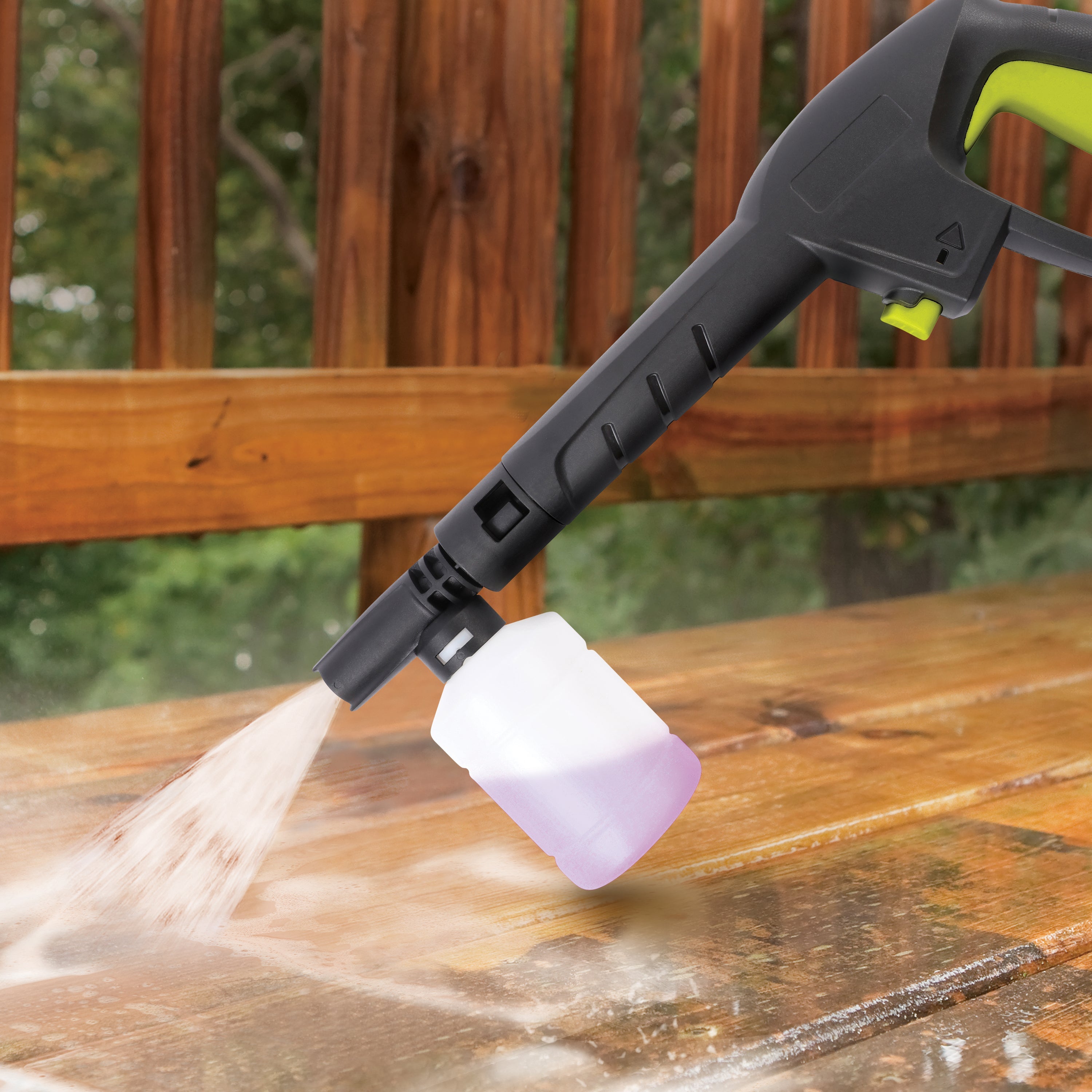 Spray wand with the foam cannon attached spraying a patio.