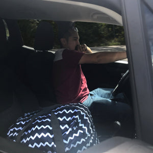 TrailGear 20-liter sky blue transparent dry bag in the passenger seat of a car.